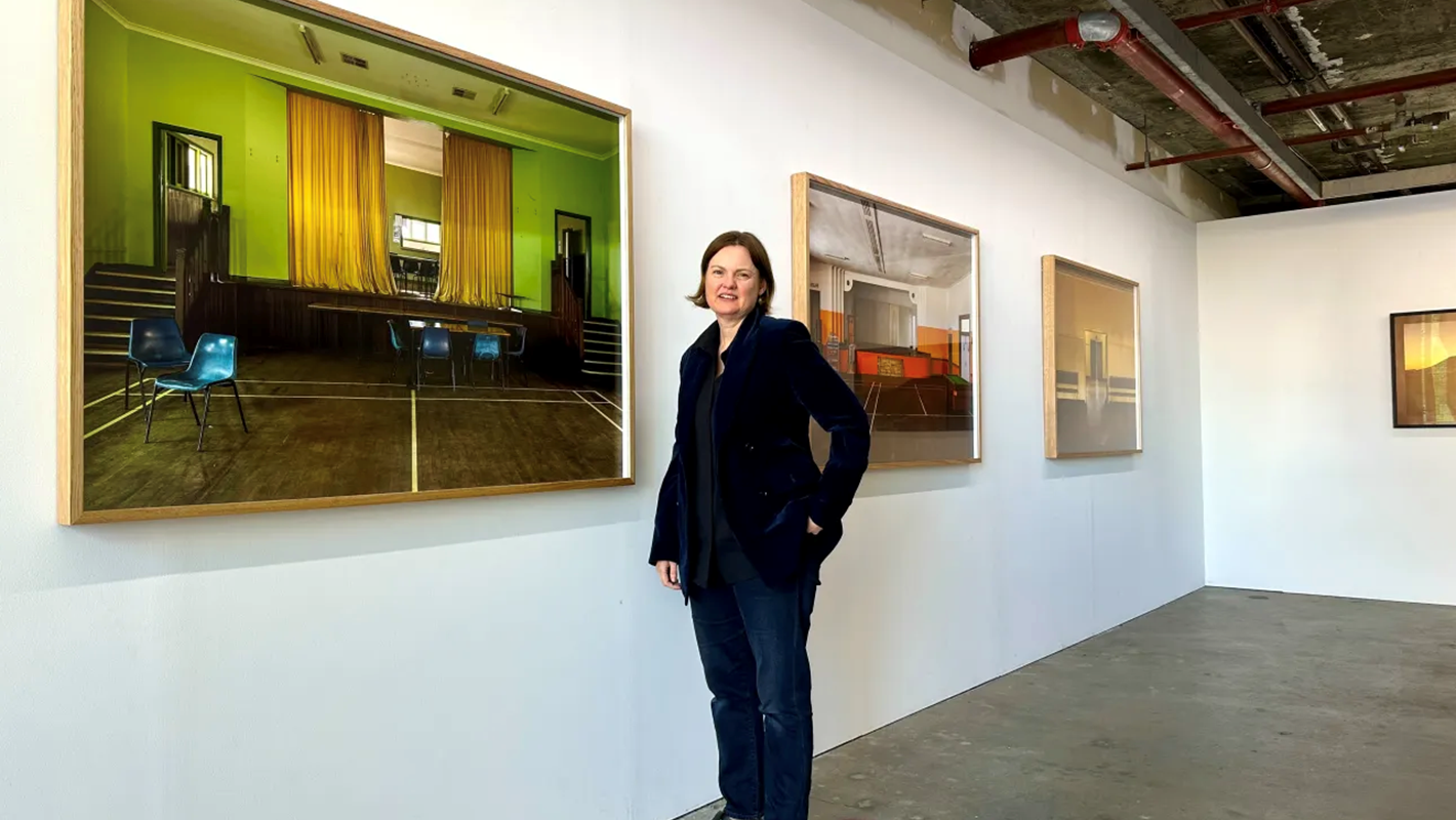 Art Collective WA Director Felicity Johnston with works from Brad Rimmer's exhibition Nowhere Near 